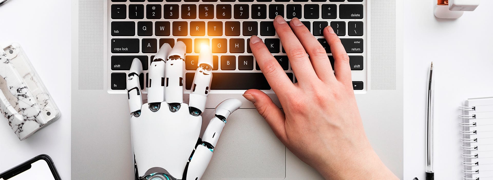 Hands typing , 1 is human and the other is a robots hand